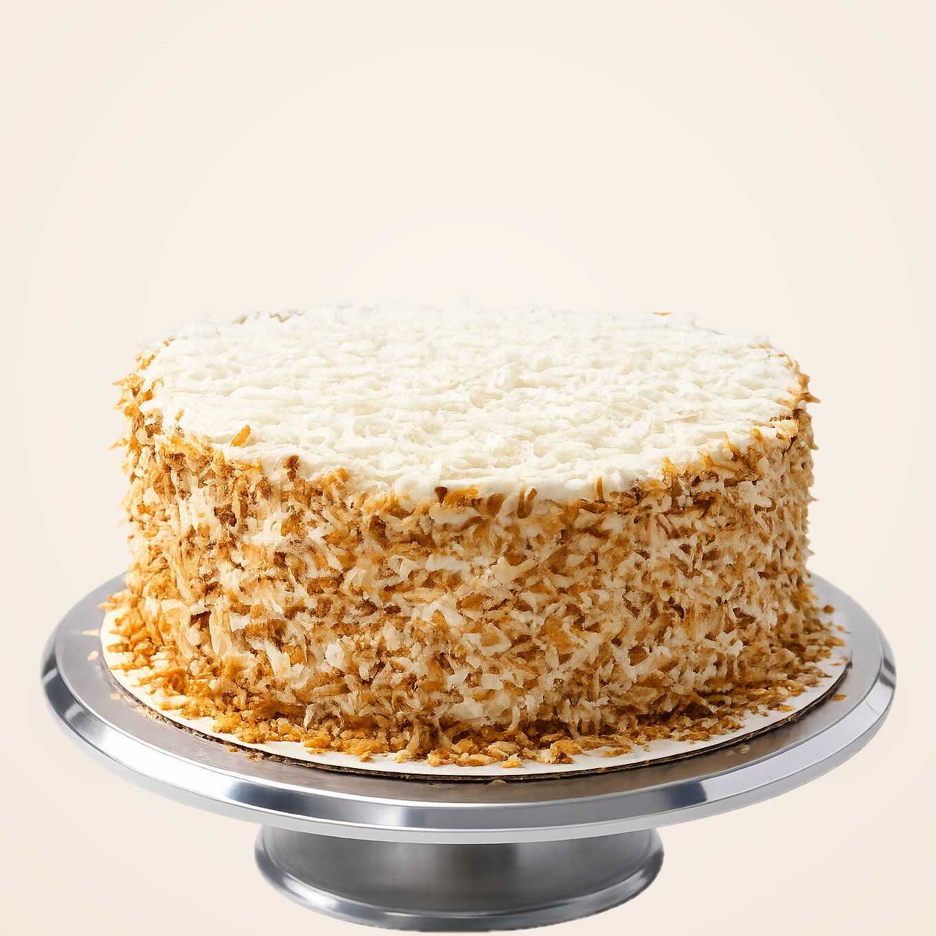 Coquito Cake — white layer cake covered in toasted coconut flakes
